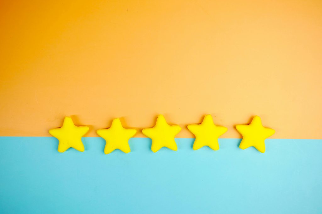 Five yellow stars symbolizing perfect customer satisfaction rating and feedback.